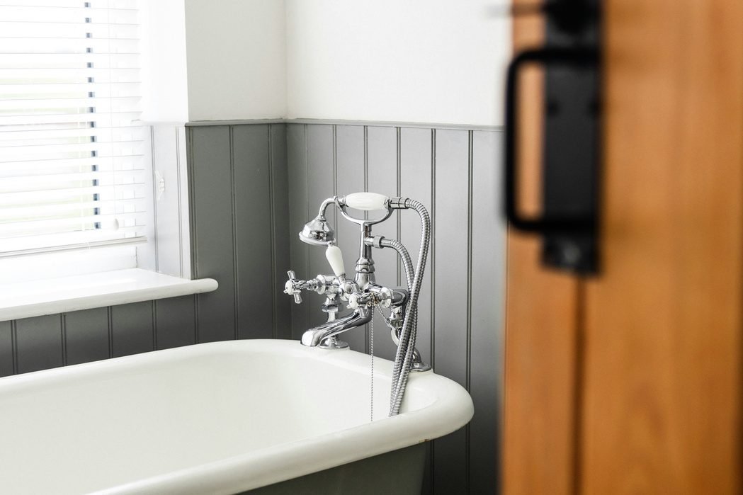 Vintage-style faucet on a white clawfoot tub