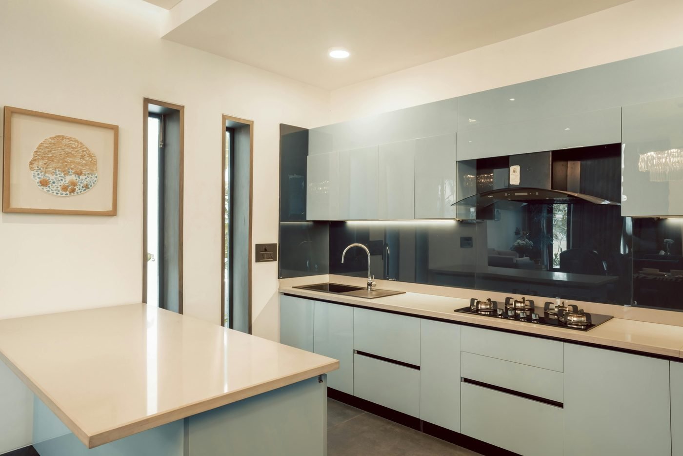 Kitchen with pale green cabinets and a wood countertop